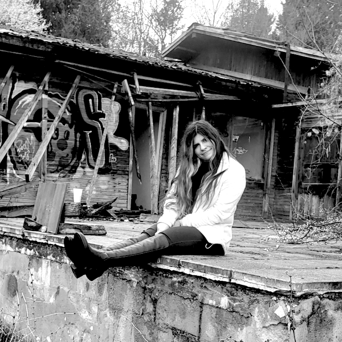 zelena sitting on the steps of an abandoned bulding
